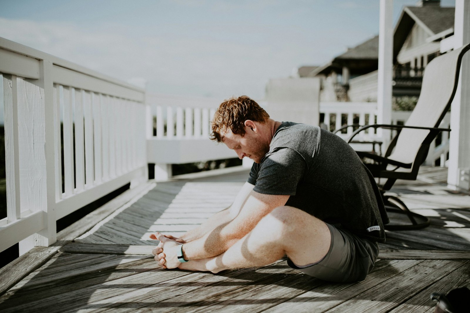 man doing yoga in porch